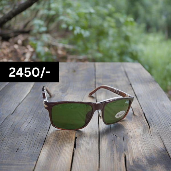 A pair of Persol Wayfarer design sunglasses with brown frame and green lenses, displayed on a wooden surface with a price tag of 2450 rupees.
