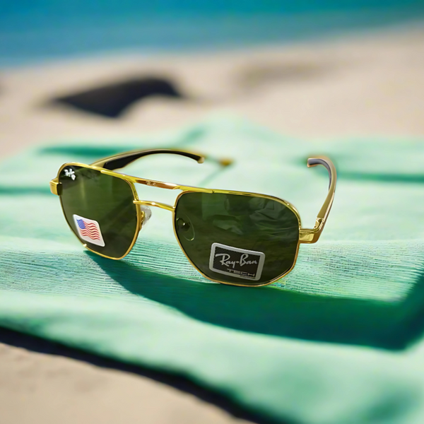A pair of Ray-Ban sunglasses with a golden frame and aluminum handle, placed on a light blue surface, with a tag indicating 'Ray-Ban' and an American flag, suggesting these are luxury, UV protected, prescription frames.