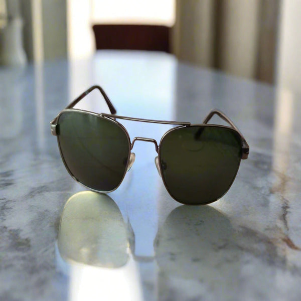 Sunglasses on a wooden surface with a blurred background