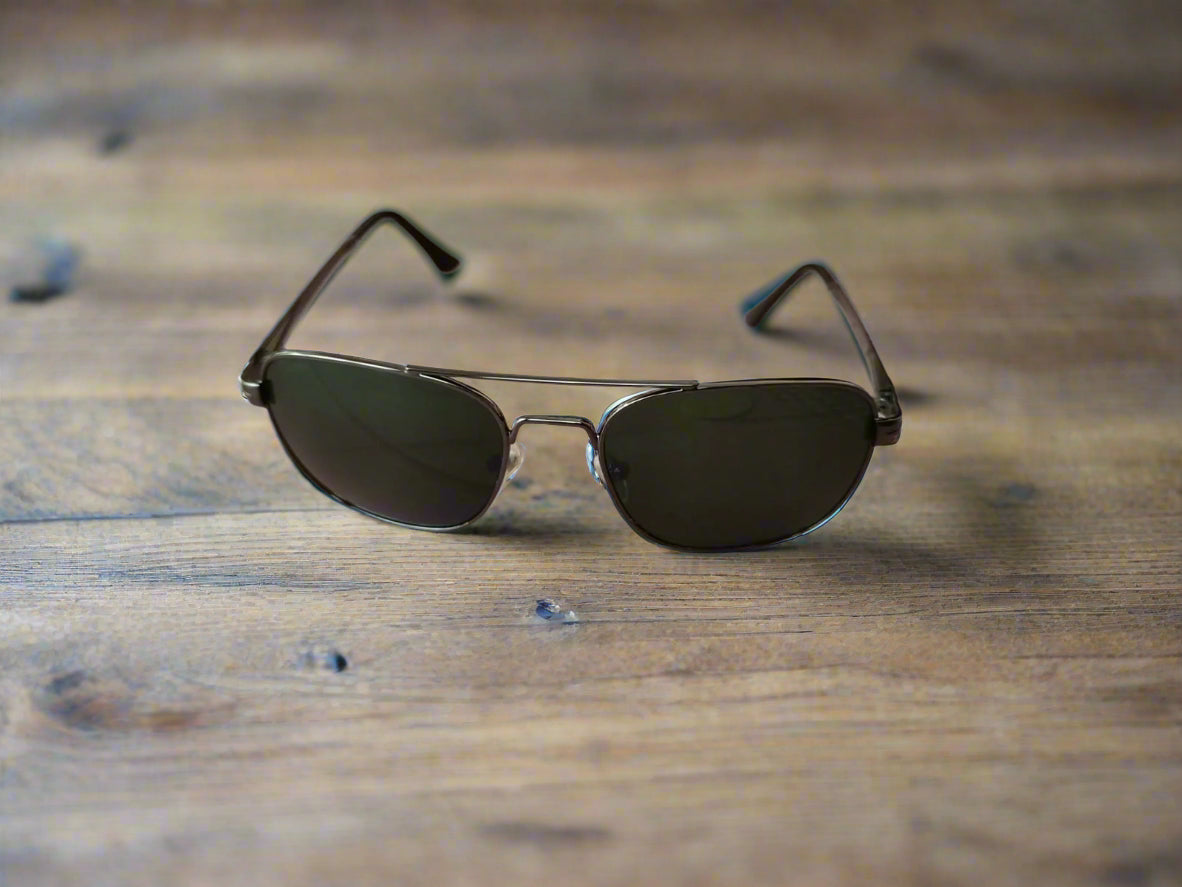 Sunglasses on a textured surface with a blurred background
