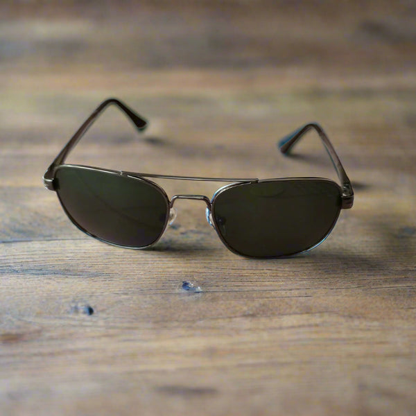 Sunglasses on a textured surface with a blurred background