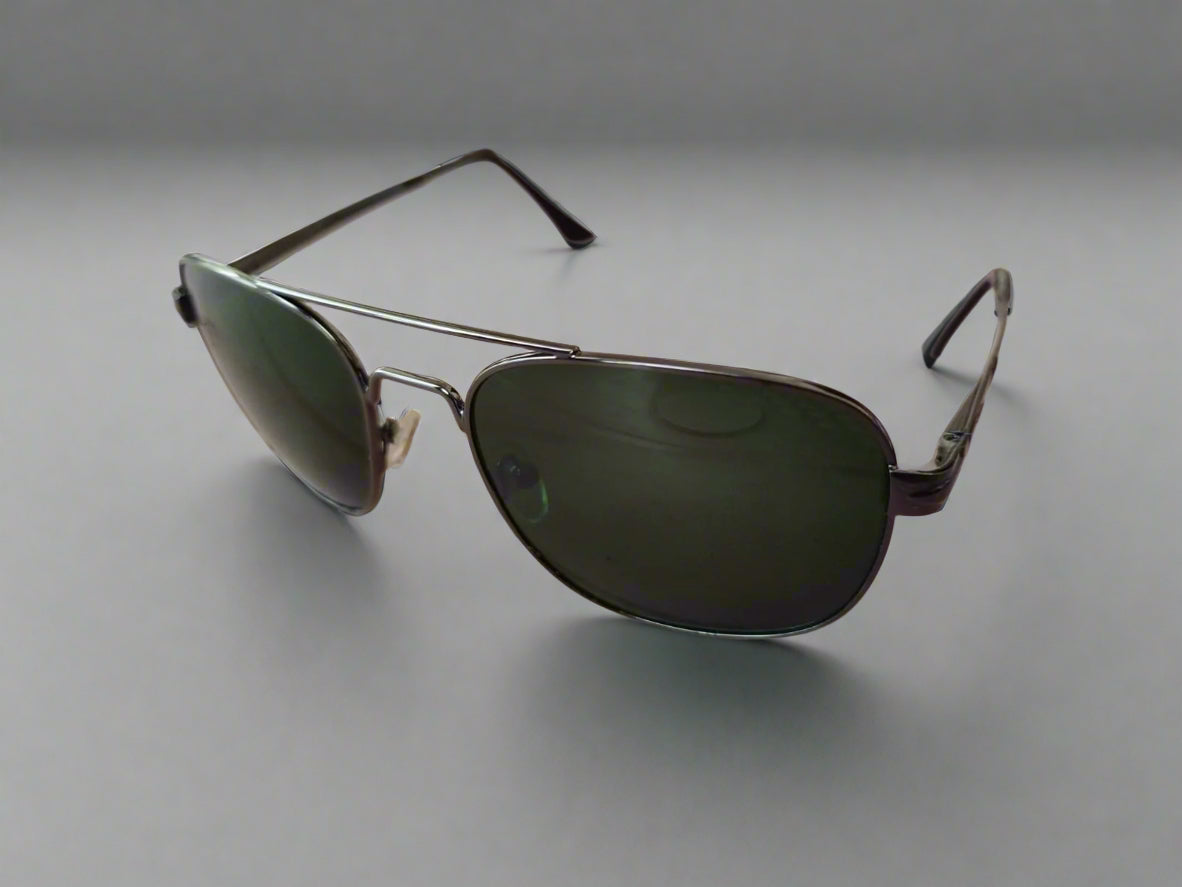 Aviator sunglasses on a textured surface with a blurred background