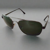 Aviator sunglasses on a textured surface with a blurred background