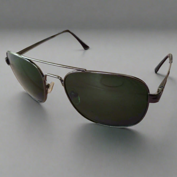 Aviator sunglasses on a textured surface with a blurred background