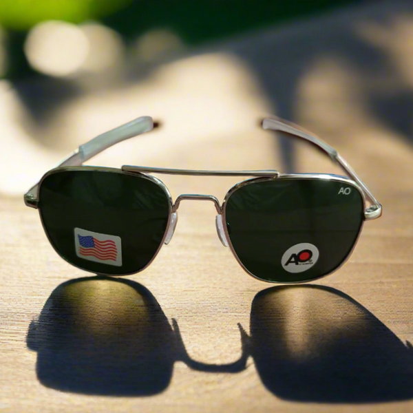 Aviator sunglasses with American flag logo on a wooden surface