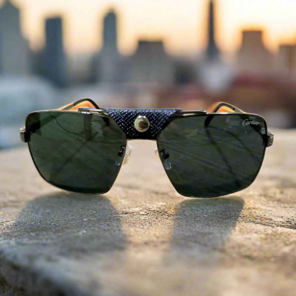 Sunglasses with a textured strap on a concrete surface with a blurred cityscape background