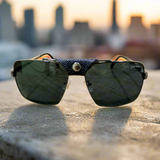 Sunglasses with a textured strap on a concrete surface with a blurred cityscape background