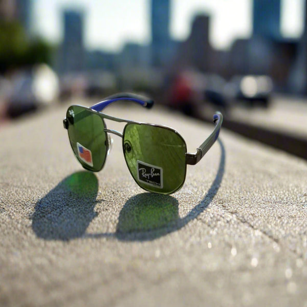 Sunglasses with green lenses and blue arms on a wooden table.