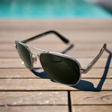 Aviator sunglasses on a textured surface with a blurred background