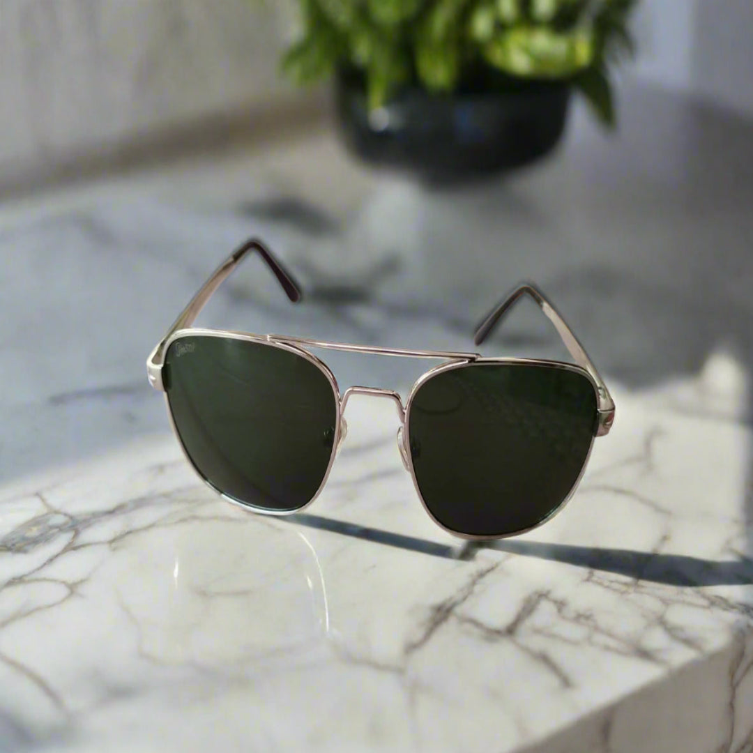 Aviator sunglasses with dark lenses on a wooden surface
