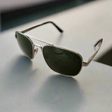Aviator sunglasses on a textured surface with a blurred background