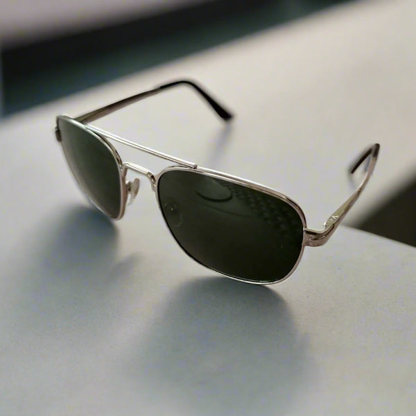 Aviator sunglasses on a textured surface with a blurred background