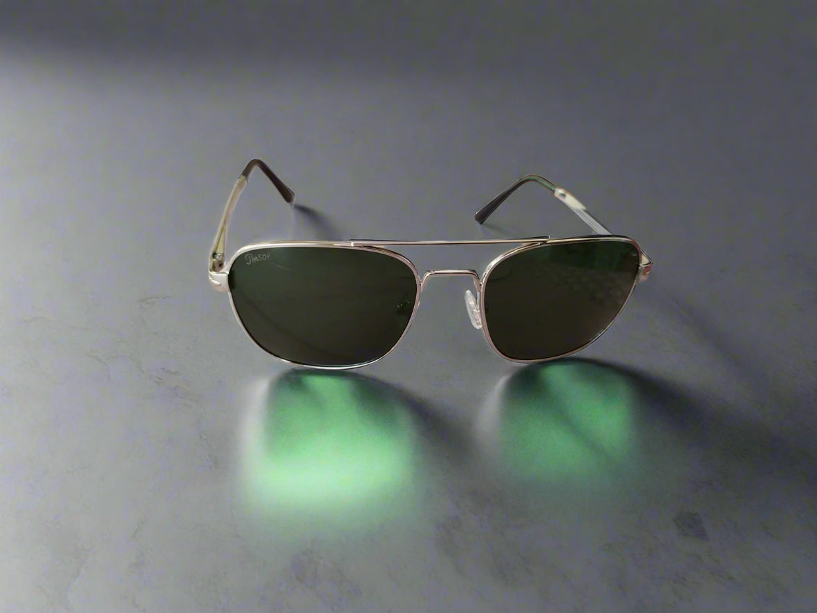 Aviator sunglasses with dark lenses on a wooden surface