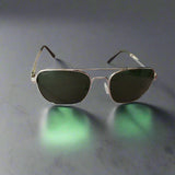 Aviator sunglasses with dark lenses on a wooden surface