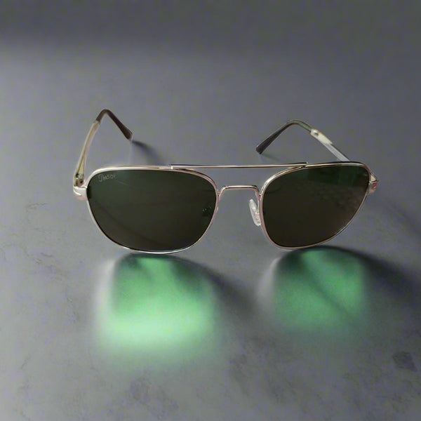 Aviator sunglasses with dark lenses on a wooden surface