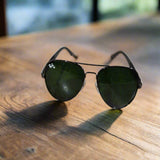 Sunglasses on a textured surface with a blurred background