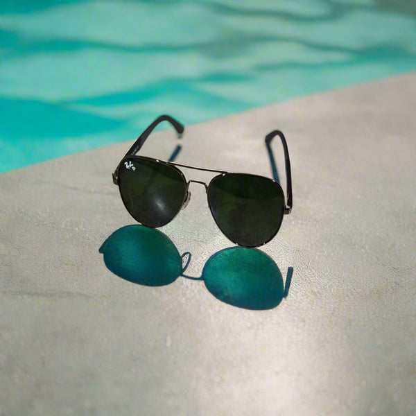 Sunglasses on a marble surface with a blurred background