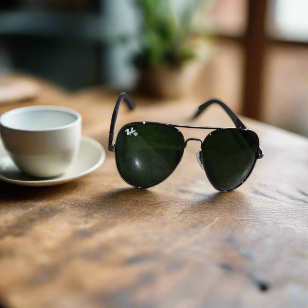 Aviator sunglasses on a textured surface with a blurred indoor background