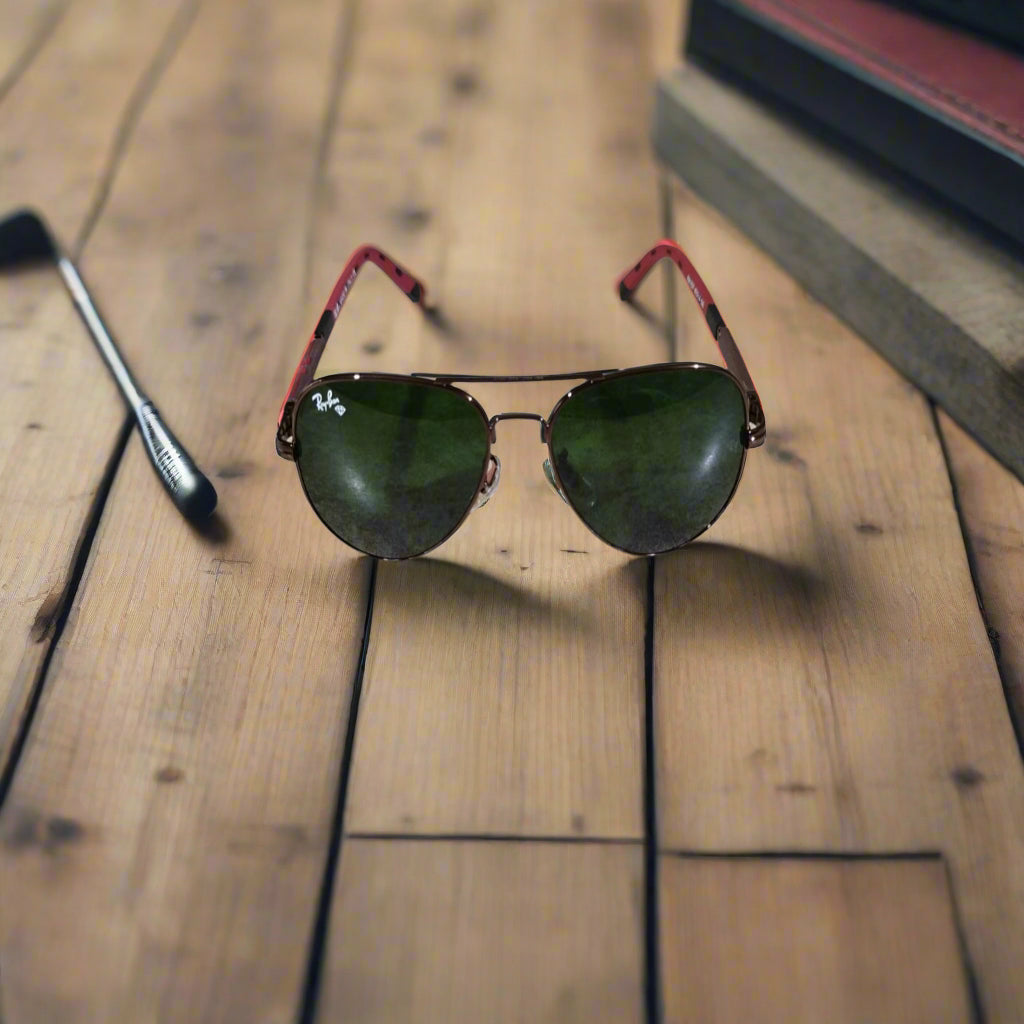 Sunglasses with red frames on a textured surface