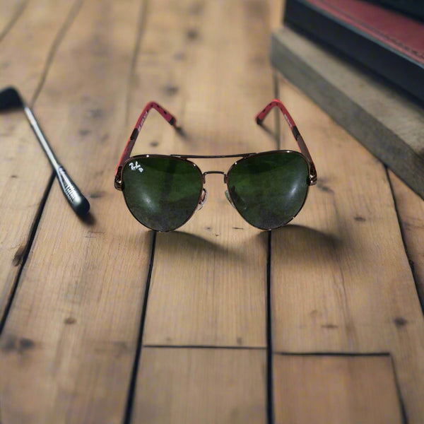 Sunglasses with red frames on a textured surface