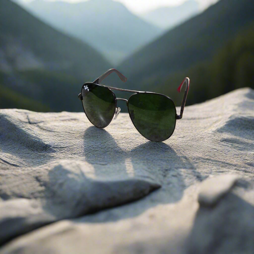 Aviator sunglasses on a textured surface with a blurred background